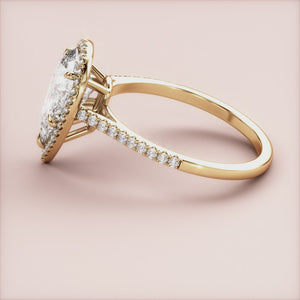"Elegant pear-shaped diamond engagement ring in 14K gold with a pave diamond band, exuding timeless sophistication."