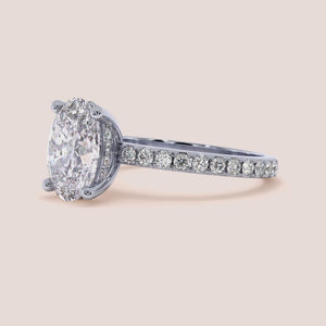 Stunning 14K or 18K gold/platinum engagement ring with a radiant round diamond in a pavé setting, perfect for proposals.
