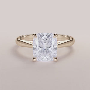 Elegant 14K or 18K yellow gold diamond engagement ring, featuring a cushion-cut solitaire in cathedral setting.
