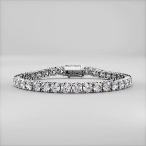 Diamond tennis bracelet on model featuring round brilliant cut diamonds in a secure four-prong setting. Available in 14K or 18K white, yellow, or rose gold. Timeless luxury and radiant sparkle for any occasion. 