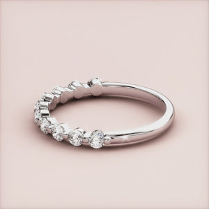 Elegant white gold or platinum half eternity wedding band with round diamonds, available in 14K and 18K for bridal elegance. 