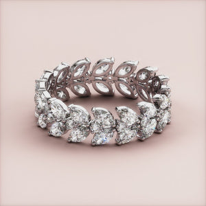 Elegant 14K and 18K white gold marquise eternity wedding band featuring sparkling diamonds and intricate detailing. 