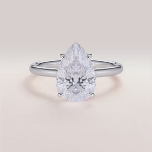 "Elegant 14K white gold engagement ring featuring a pear-shaped diamond, an invisible gallery, and a hidden halo design.
