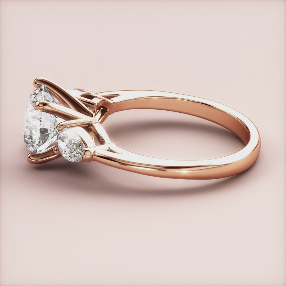 "Stunning 14K rose gold engagement ring with three sparkling stones, perfect for a romantic proposal.|







#14KRecycledRoseGold
#18KRecycledRoseGold


"

