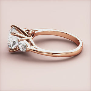 "Stunning 14K rose gold engagement ring with three sparkling stones, perfect for a romantic proposal.