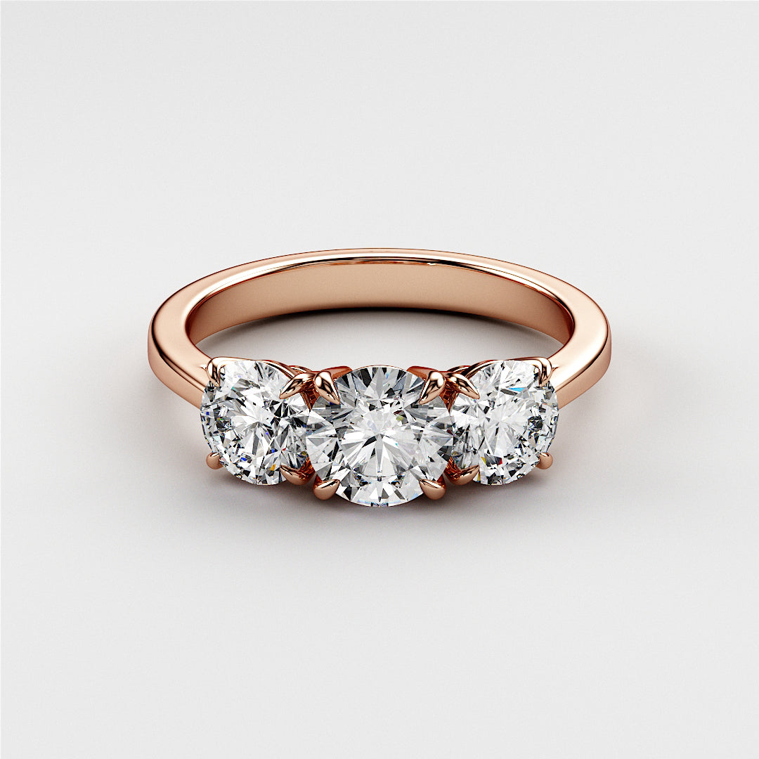 Elegant tri-stone wedding band with a round diamond center, set in 14K or 18K rose gold, showcasing glamour and sophistication.Elegant oval diamond solitaire engagement ring in 14K or 18K rose gold, featuring a hidden halo and plain band.