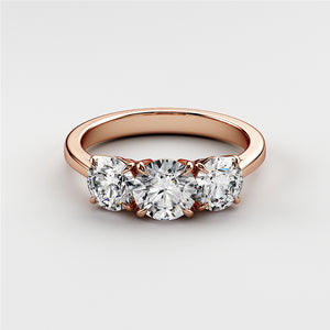 Elegant tri-stone wedding band with a round diamond center, set in 14K or 18K rose gold, showcasing glamour and sophistication.Elegant oval diamond solitaire engagement ring in 14K or 18K rose gold, featuring a hidden halo and plain band.