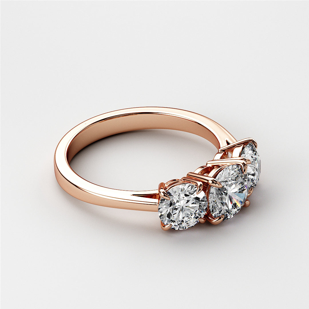 Rose gold three-stone wedding band featuring round brilliant-cut diamonds, available in 14K and 18K gold or platinum.