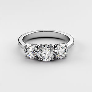 Three-stone round diamond wedding band in 14K/18K gold or platinum, featuring brilliant diamonds, not worn on a model.Elegant oval diamond solitaire engagement ring in 14K or 18K rose gold, featuring a hidden halo and plain band.