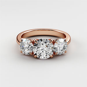 Elegant rose gold wedding band featuring three round diamonds, available in 14K, 18K, or platinum for timeless sparkle. 