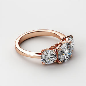 Elegant 14K Rose Gold Three-Stone Wedding Band with round diamonds, featuring a central brilliant gem and classic design. 