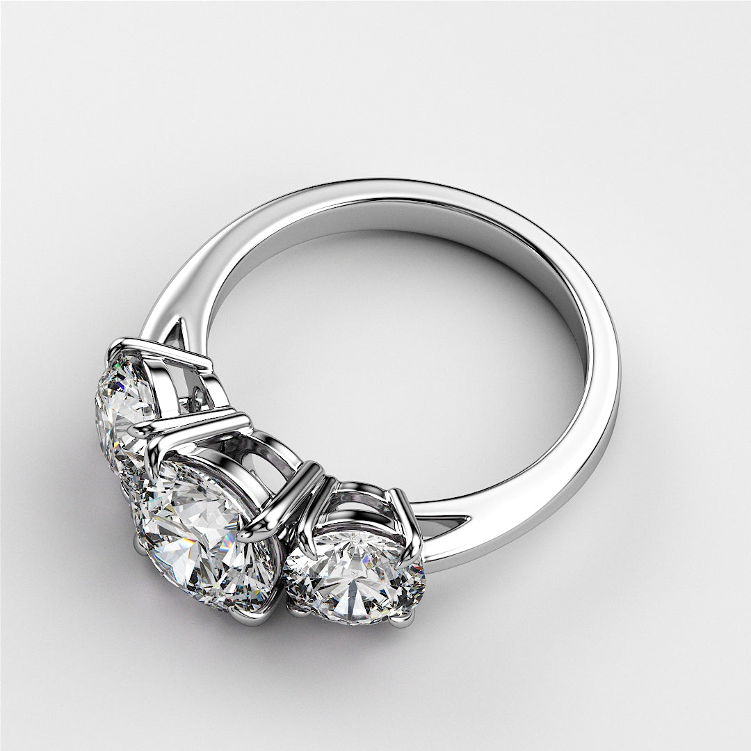 Elegant three-stone white gold wedding band featuring round diamonds, available in 14K or 18K and platinum. 