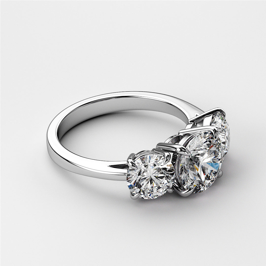 Elegant three-stone wedding band in 14K/18K gold or platinum, featuring round brilliant diamonds in a timeless design. 