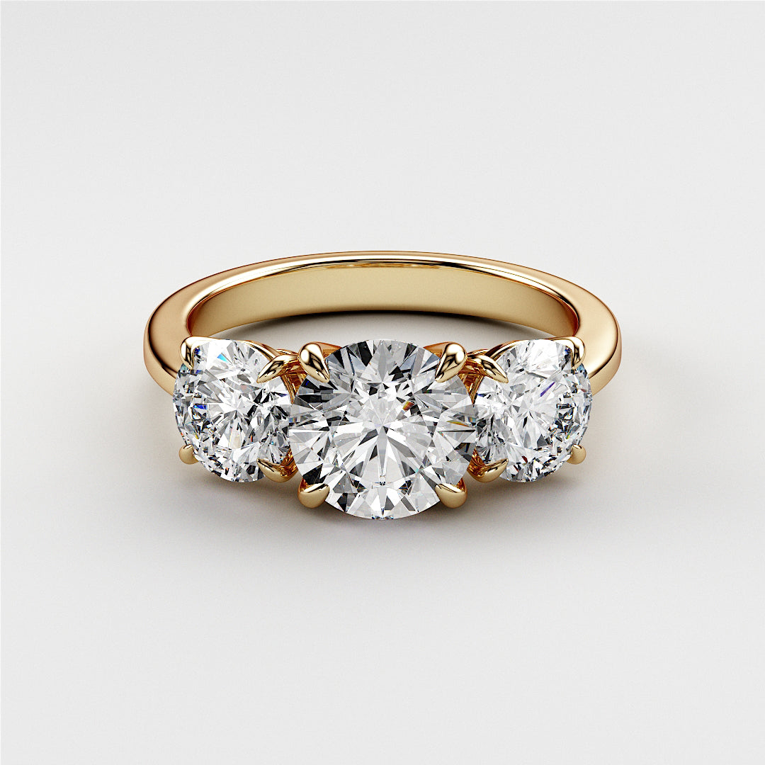Elegant wedding band in 14K or 18K yellow gold featuring a three-stone design with sparkling round diamonds. 