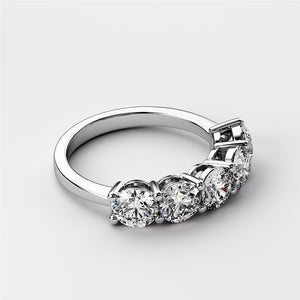 Elegant 14K or 18K gold or platinum wedding band featuring five round diamonds in classic prongs for a timeless look. 