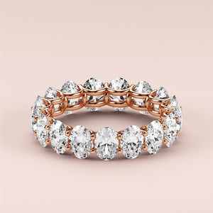 Elegant 14K rose gold eternity band with round-cut diamonds in prong setting, perfect for weddings and celebrations. 