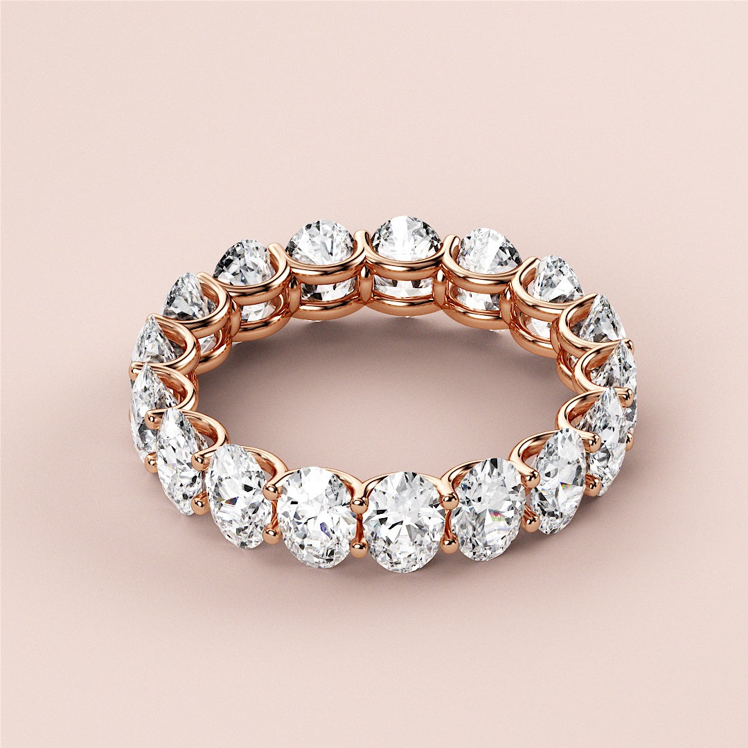 Elegant 14K/18K rose gold oval eternity wedding band, featuring brilliant cut diamonds and timeless design for radiant sparkle. 