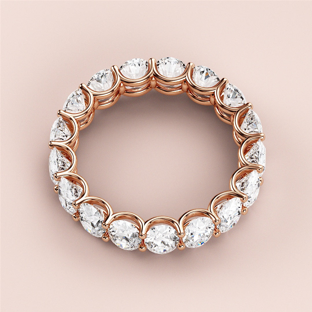 Rose gold eternity wedding band with round-cut diamonds, available in 14K, 18K, or platinum for timeless elegance. 