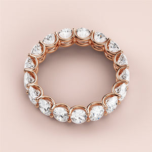 Rose gold eternity wedding band with round-cut diamonds, available in 14K, 18K, or platinum for timeless elegance. 