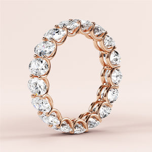 Elegant 14K or 18K rose gold diamond eternity wedding band with round brilliant-cut diamonds in shared prong setting. 