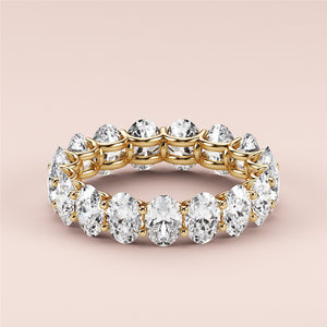 Worn-on-model 14K yellow gold eternity band with round brilliant diamonds, perfect for weddings and special occasions. 