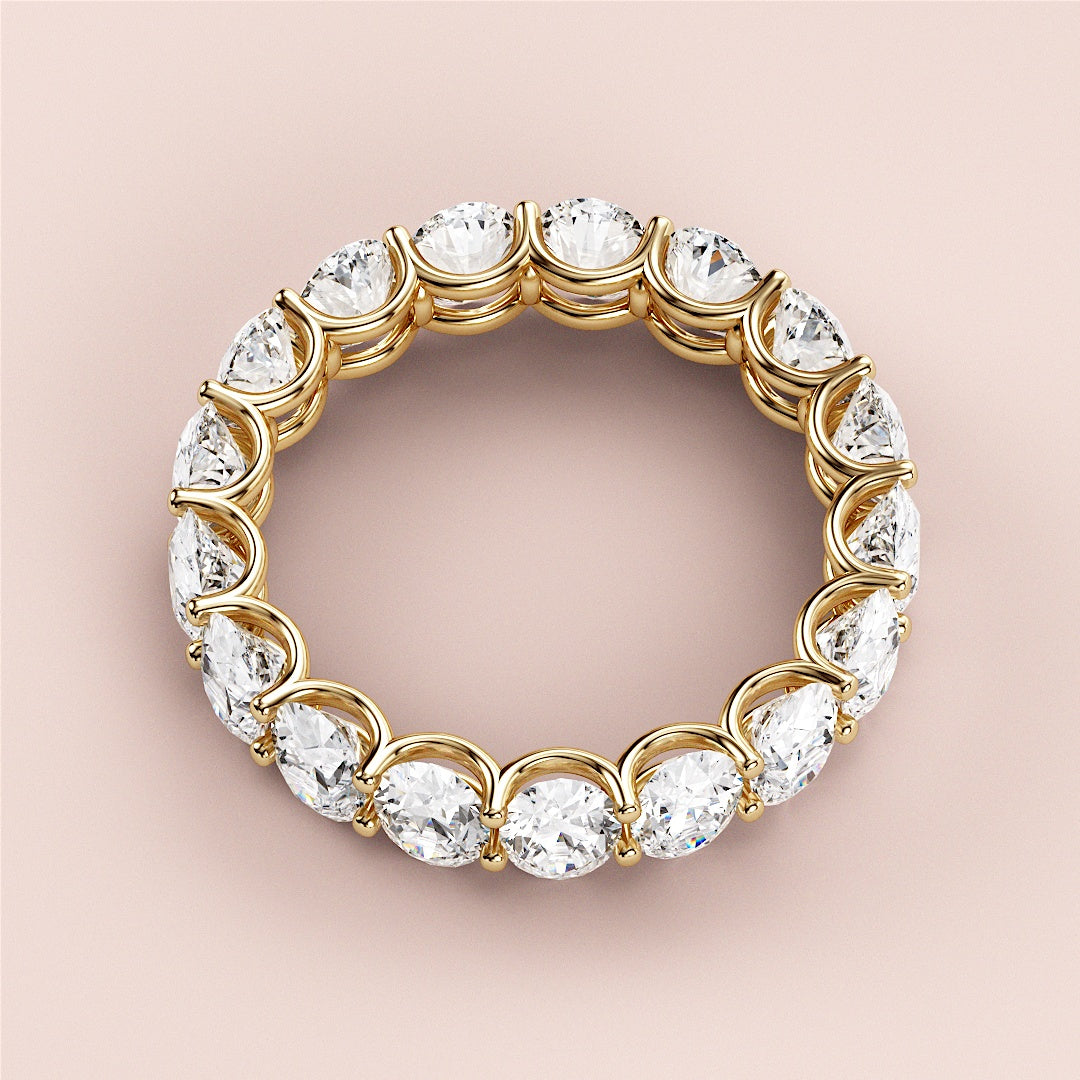 Elegant yellow gold wedding band featuring round brilliant-cut diamonds, available in 14K, 18K, or platinum. Perfect for eternity. 