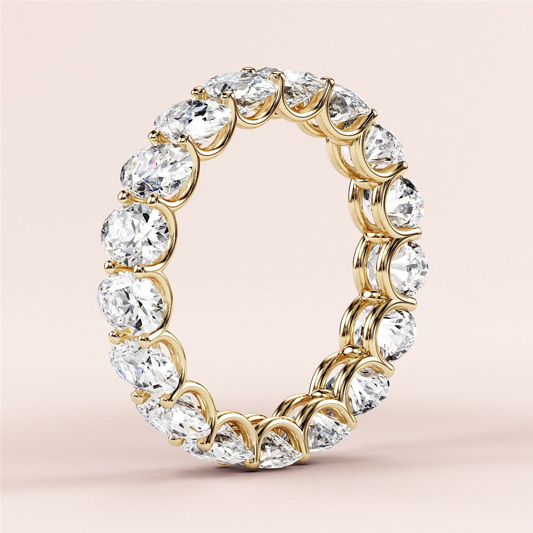 Elegant 14K yellow gold eternity wedding band with round brilliant cut diamonds, offering a luxurious and timeless design. 