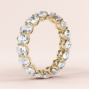 Elegant 14K yellow gold eternity wedding band with round brilliant cut diamonds, offering a luxurious and timeless design. 