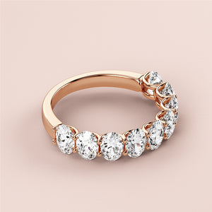 Elegant 14K rose gold wedding band featuring seven sparkling round diamonds in a prong setting, perfect for eternal love. 