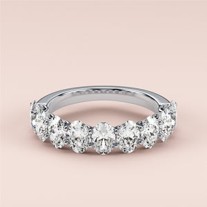 Elegant 14K, 18K, or platinum oval half eternity wedding band featuring pear-shaped diamonds against a neutral background. 