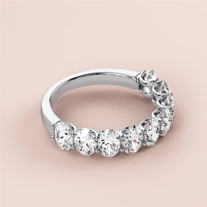 Elegant 14K/18K white gold wedding band featuring round brilliant cut diamonds, displayed on a beige background. 
