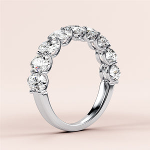 Elegant 14K-18K or platinum oval half-eternity wedding band with round brilliant-cut diamonds, perfect for special occasions. 