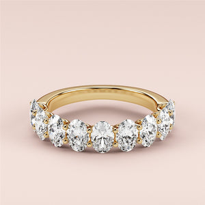 Gold eternity wedding band featuring round brilliant-cut diamonds; available in 14K, 18K, or platinum options. 
