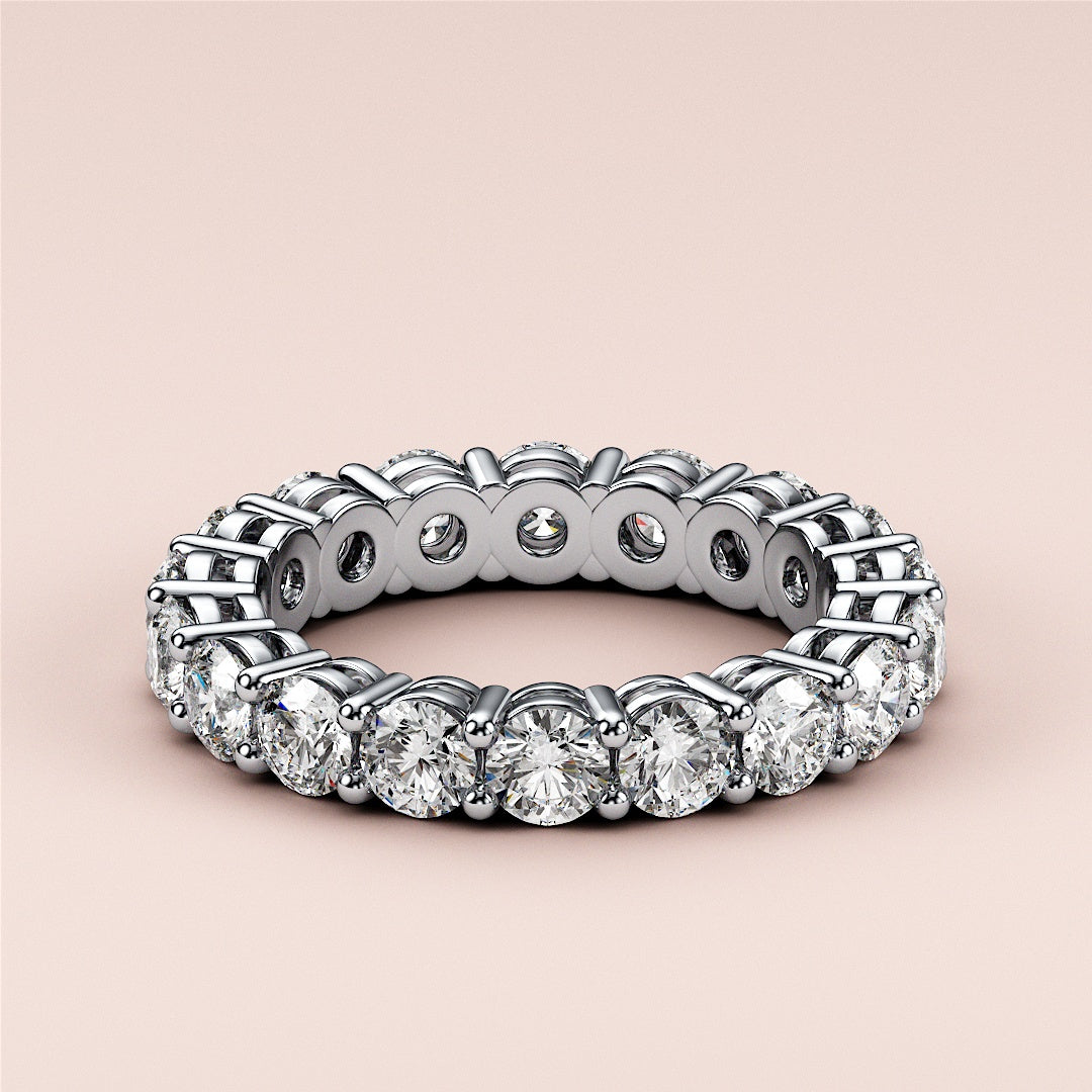 Elegant 14K or 18K gold or platinum wedding band featuring a continuous circle of diamonds, perfect for eternity and daily wear. 