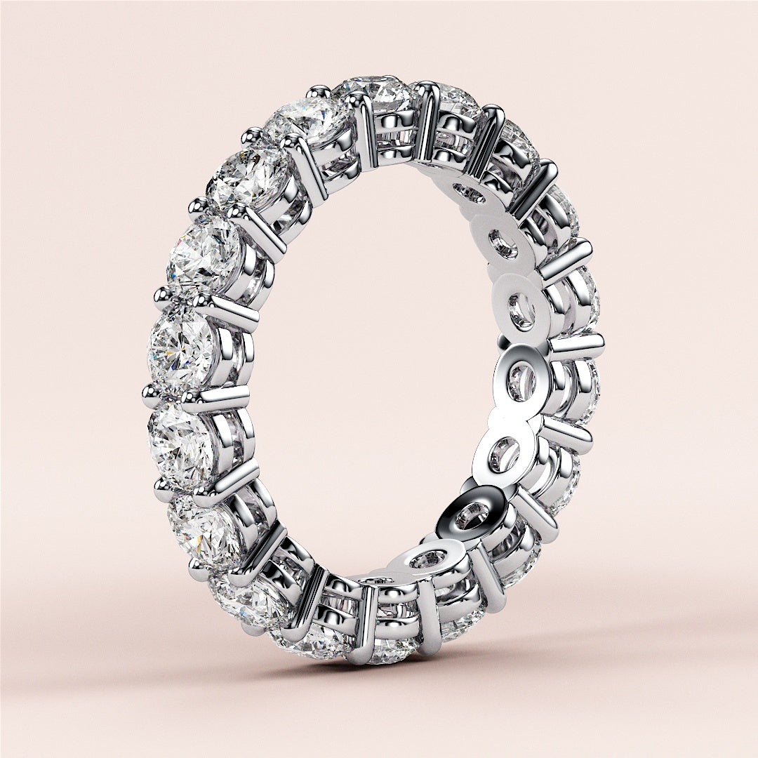 Elegant round-cut eternity wedding band in 14K or 18K gold or platinum, featuring a continuous row of sparkling diamonds. 