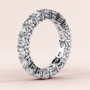 Elegant round-cut eternity wedding band in 14K or 18K gold or platinum, featuring a continuous row of sparkling diamonds. 