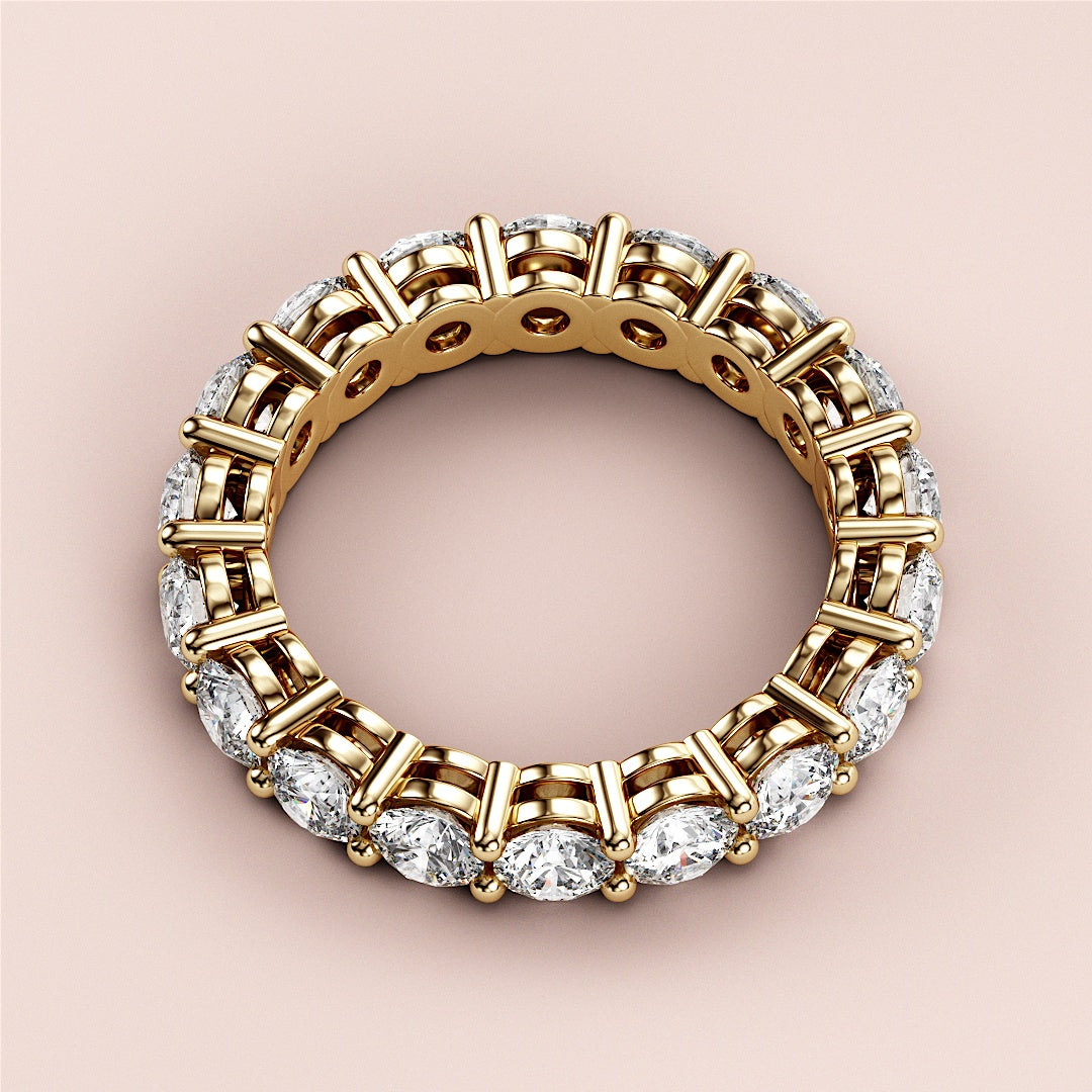 14K yellow gold eternity band ring featuring round brilliant-cut diamonds, elegantly worn on a model for a timeless wedding look. 