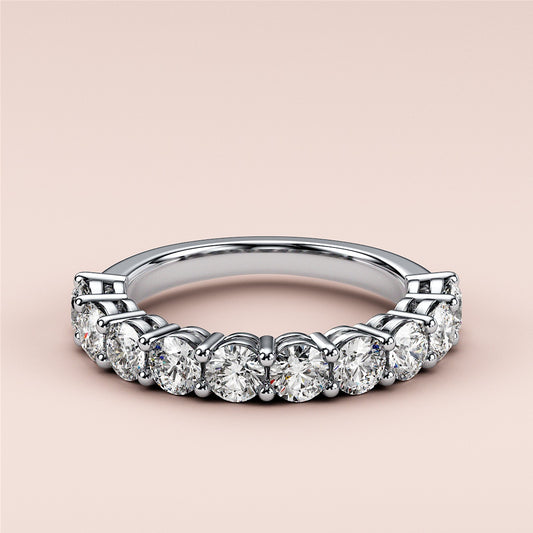 Stunning white gold eternity wedding band with brilliant round-cut diamonds in prong setting, available in 14K, 18K, and platinum. 