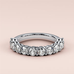 Stunning white gold eternity wedding band with brilliant round-cut diamonds in prong setting, available in 14K, 18K, and platinum. 