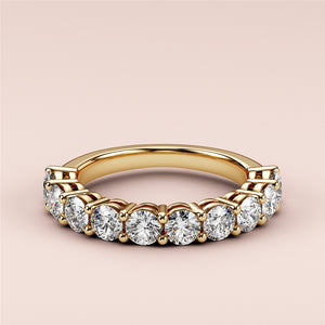 Elegant 14K or 18K yellow gold wedding band featuring round brilliant-cut diamonds in a prong setting, perfect for eternity. 