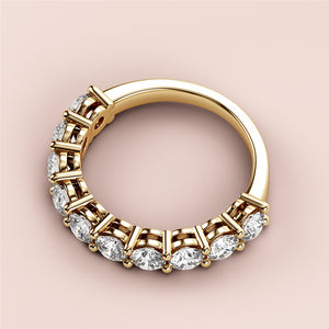 Yellow gold wedding band with round diamonds in prong setting, available in 14K and 18K or platinum, showcased on neutral background. 