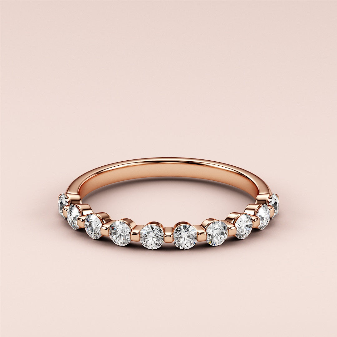 Elegant 14K or 18K rose gold eternity band featuring round brilliant diamonds, showcasing timeless beauty and luxury. 