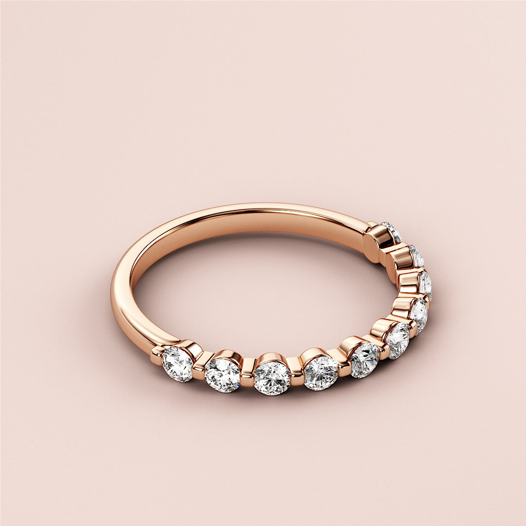 Elegant rose gold half eternity wedding band featuring round brilliant diamonds, available in 14K, 18K, or platinum. 