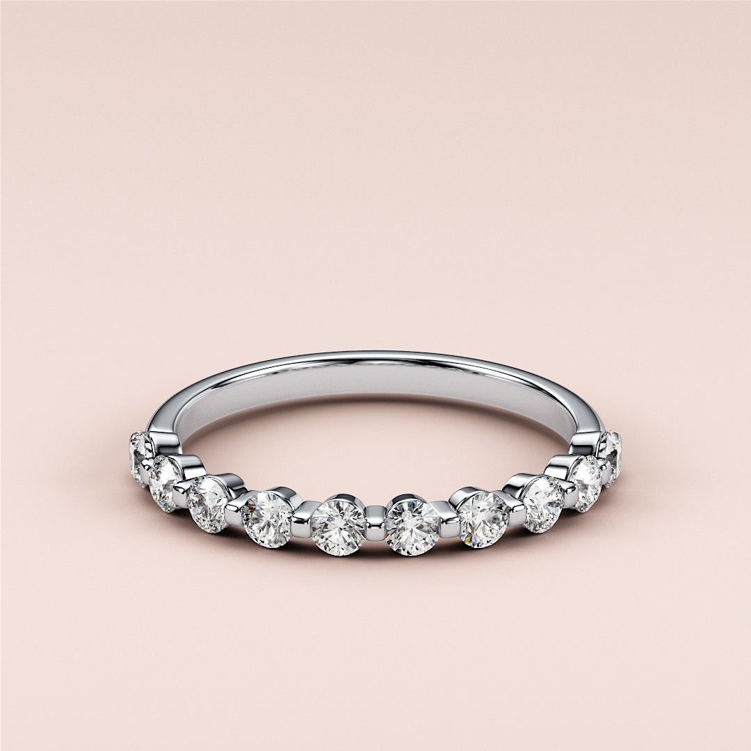 Elegant round diamond eternity band in 14K white gold, featuring alternating brilliant diamonds.  Ideal for weddings and anniversaries. 