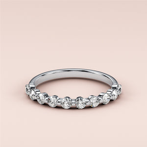 Elegant round diamond eternity band in 14K white gold, featuring alternating brilliant diamonds.  Ideal for weddings and anniversaries. 