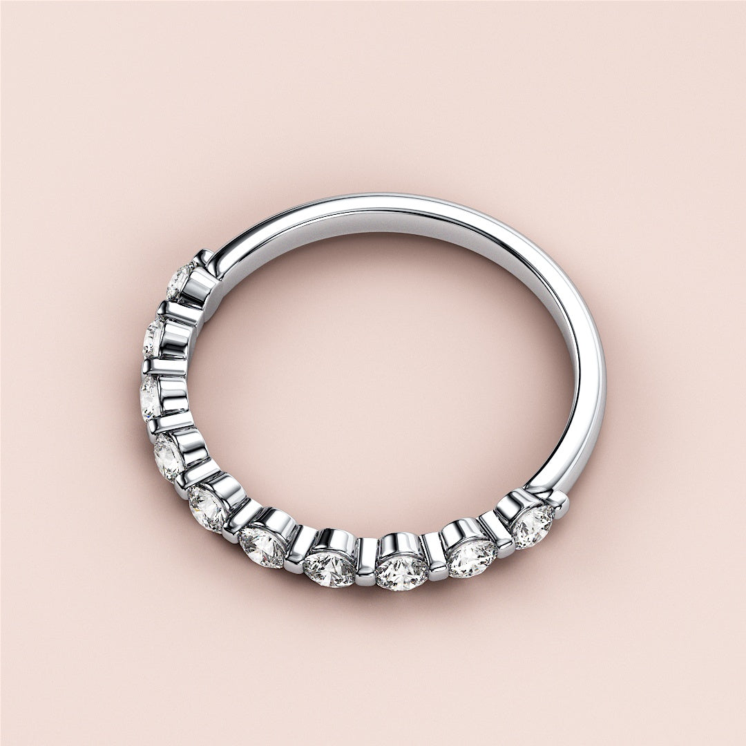 Elegant diamond eternity ring in 14K/18K white gold, featuring round diamonds in a half-eternity band, perfect for weddings. 