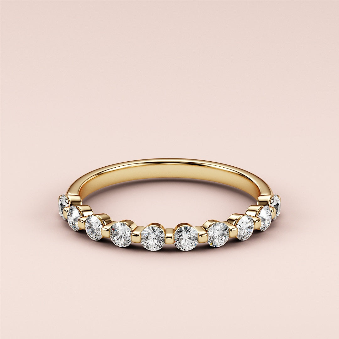 Elegant 14K Yellow Gold half eternity wedding band with round cut diamonds for timeless style and beauty. 