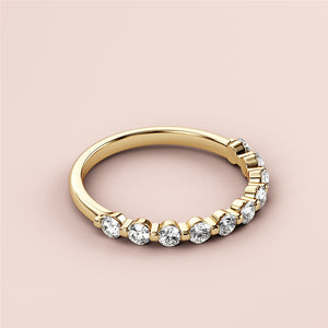 Elegant 14K gold wedding band featuring a row of round brilliant-cut diamonds on a soft pink background. 