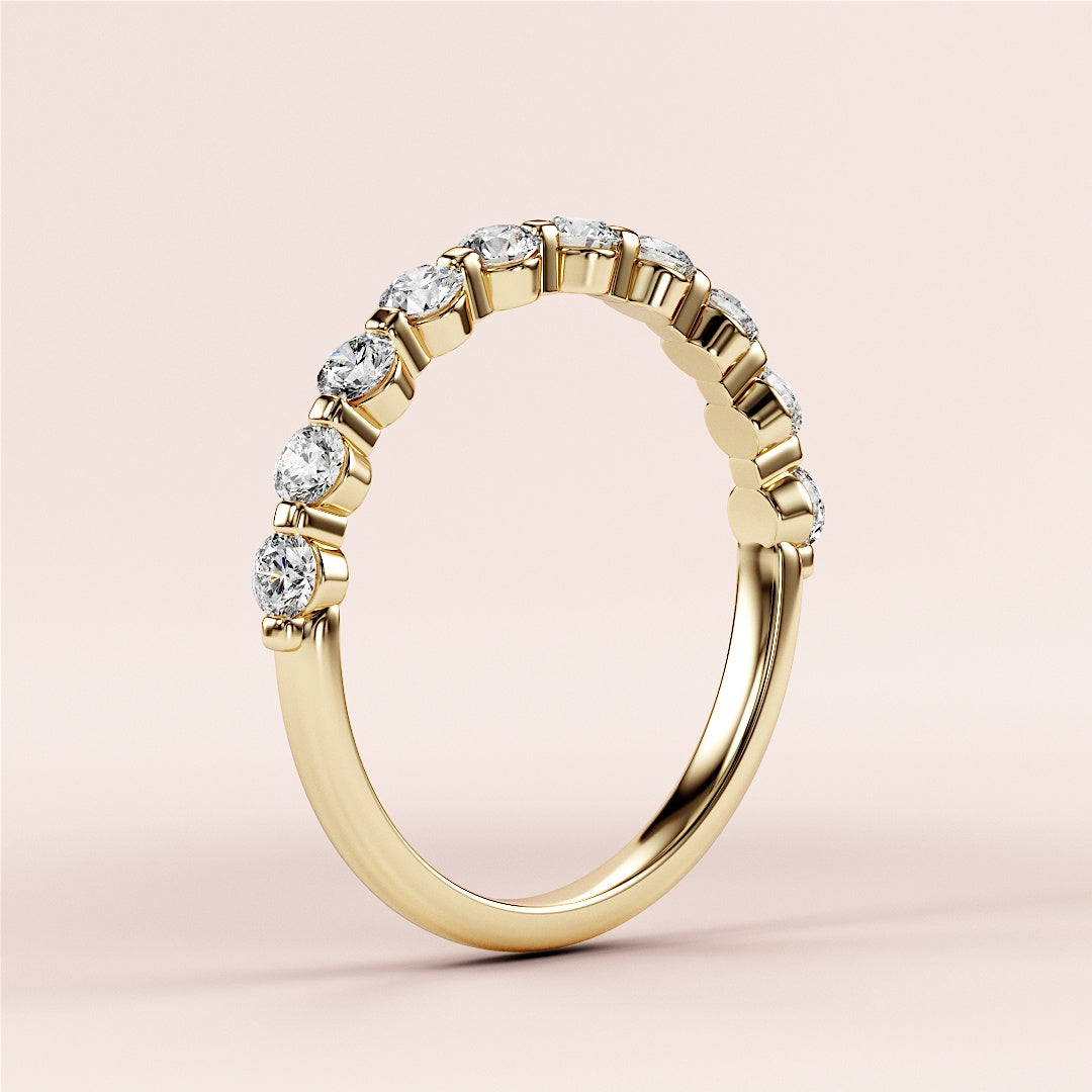 Elegant 14K or 18K yellow gold eternity band with round brilliant-cut diamonds, perfect for timeless wedding jewelry. 