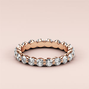 Elegant rose gold eternity band with round brilliant-cut diamonds in prong setting, available in 14K, 18K, and platinum. 